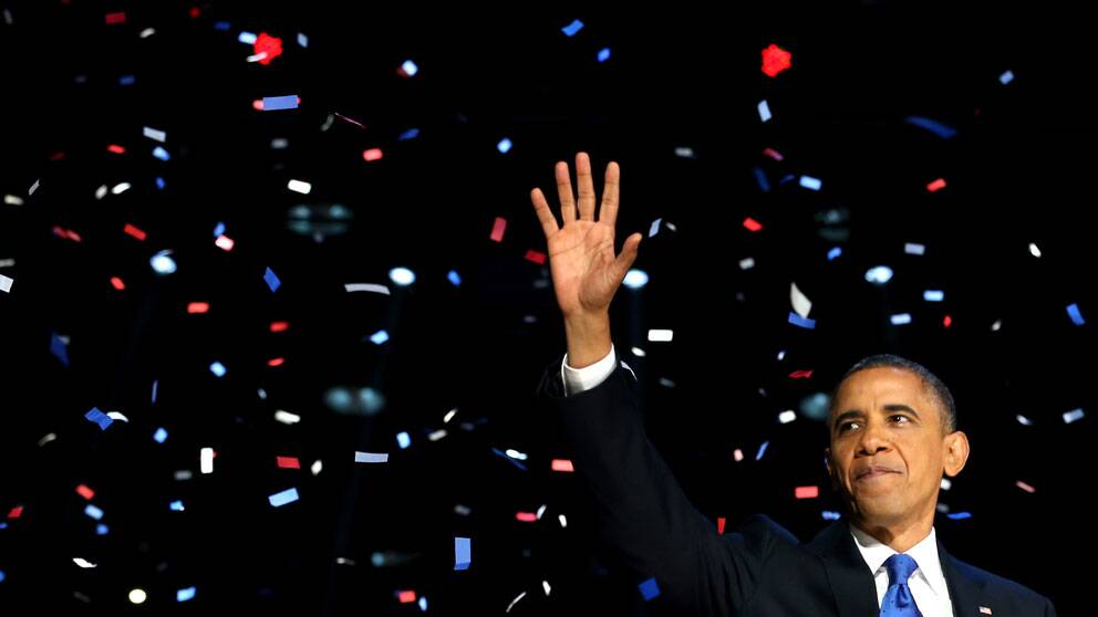 Barack Obama väljs om till USA:s president för ytterligare fyra år. På scenen i Chicago mottar han publikens jubel.