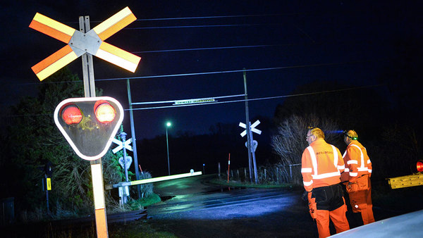 Personal från Infranord spärrar av en järnvägsövergång i Spannarp utanför Helsingborg där kontaktledningen hänger ner efter stormen Gorm. Foto: Johan Nilsson/TT