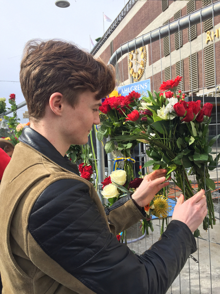 Simon Myrén lämnar blommor utanför Åhléns.
- Jag vill visa ett solidariskt stöd. Det är det minsta man kan göra, säger han.
